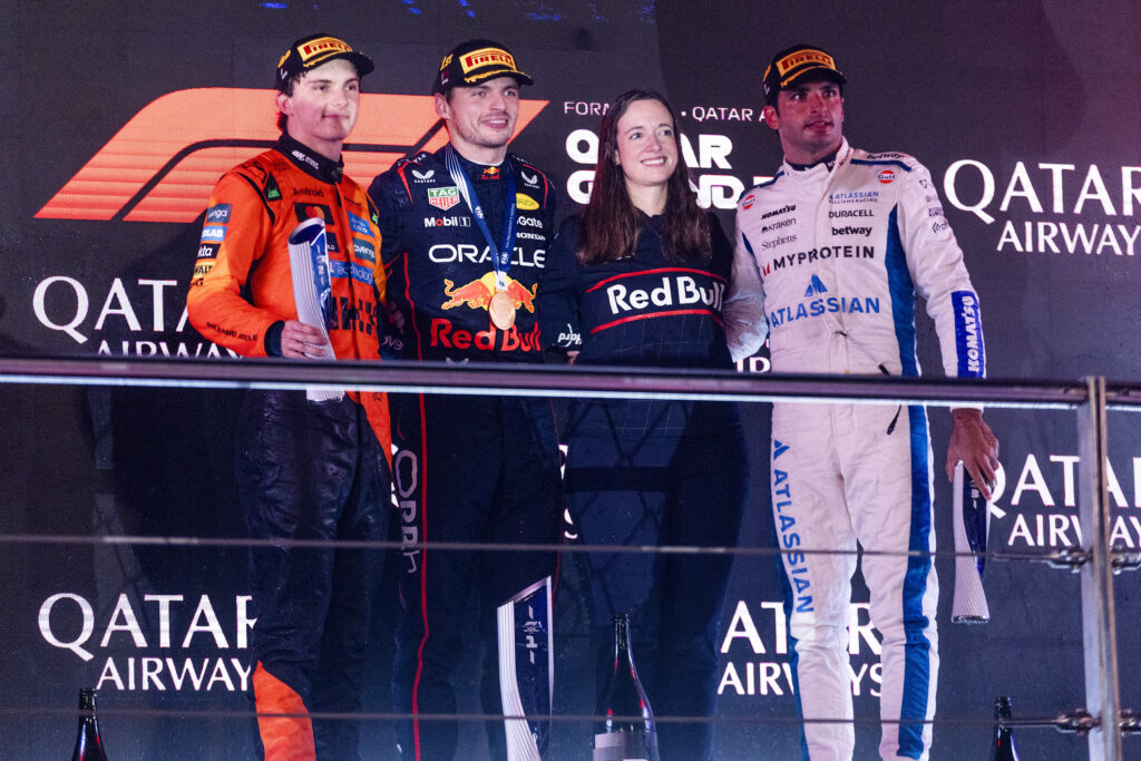 1. F1 drivers on podium celebrating after race at Qatar Airways Qatar Grand Prix.