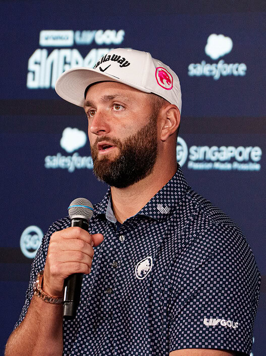 HSBC Singapore Golf event speaker holding microphone at a corporate event.