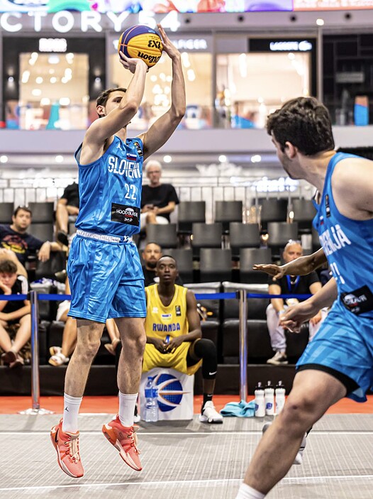 Basketball player shooting during a game at baseline.sg.