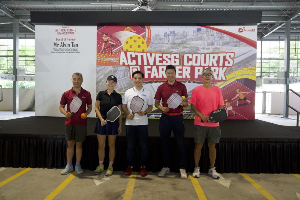 Active seniors playing table tennis at Activest Courts in a spacious indoor sports facility.