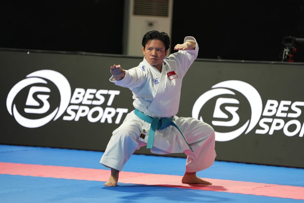 Karate athlete performing a kata in a competition setting at baseline.sg.