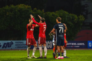 Balestier Tigers players celebrating during a football match against Albirex.