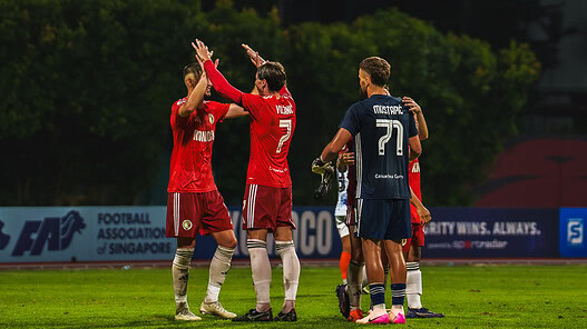 Balestier Tigers players celebrating during a football match against Albirex.