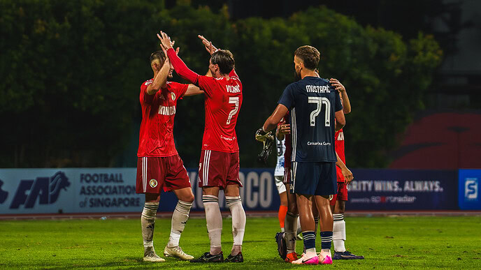 Balestier Tigers players celebrating during a football match against Albirex.