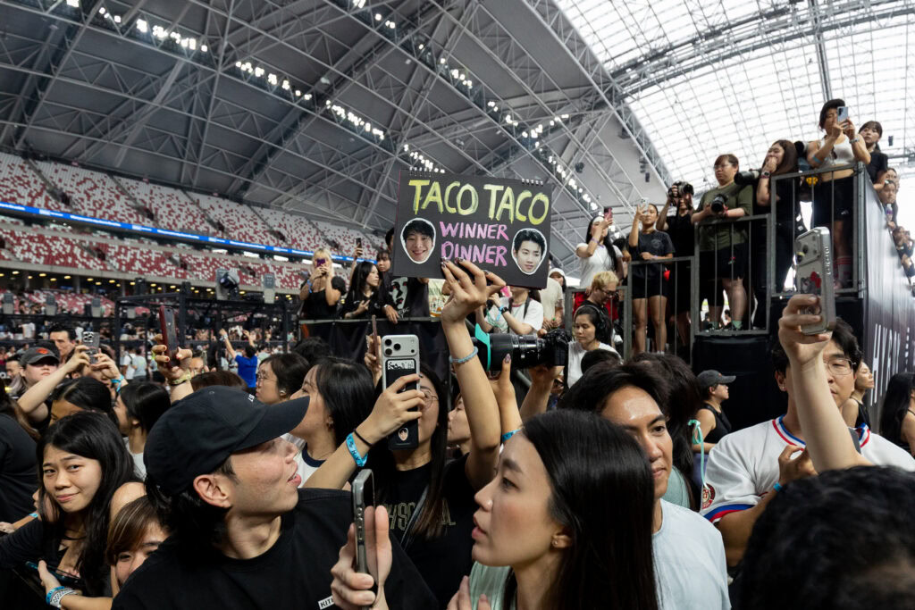 Crowd at AIA HYROX Singapore event with Taco Taco sign and participants.